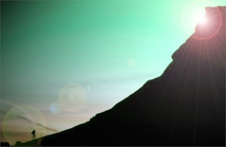 A steep mountainside with a tiny figure at the bottom of the slope.