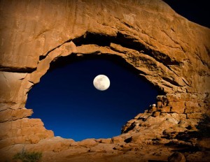 View of the moon through a rock formation giving the impression of an eye.